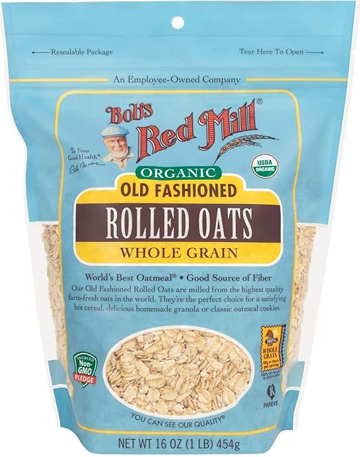 
A bag of Bob's Red Mill Organic Old Fashioned Rolled Oats Whole Grain with the USDA Organic seal and Non-GMO Project Verified label. The packaging features the brand's logo, a portrait of Bob, and a transparent window displaying the oats.